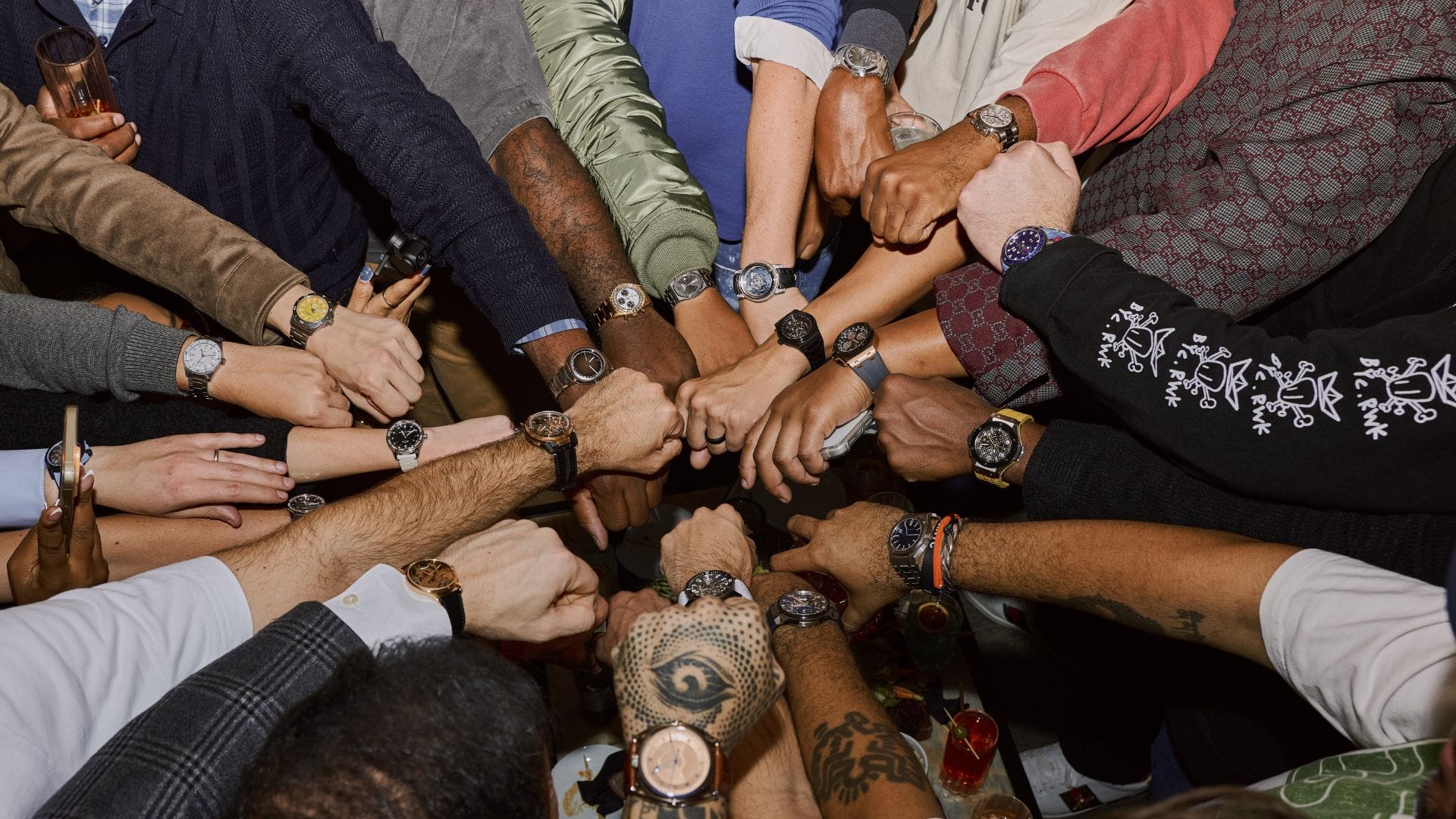 Group of watch enthusiasts showing their watches together at New York Watch Week, capturing a mix of brands and personalities.