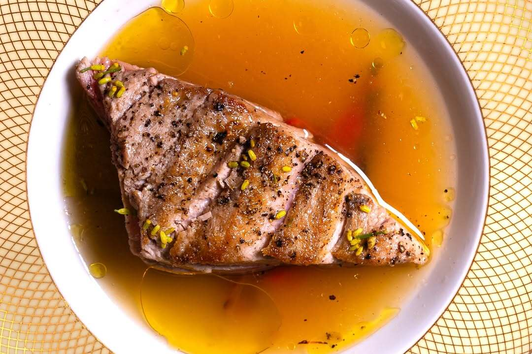 Seared fish fillet served in a light sauce with herbs at Le Chêne, a modern French restaurant in the West Village.