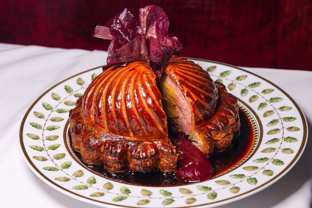 Roasted poultry dish with crisp skin and seasonal accompaniments served at Le Chêne in New York.