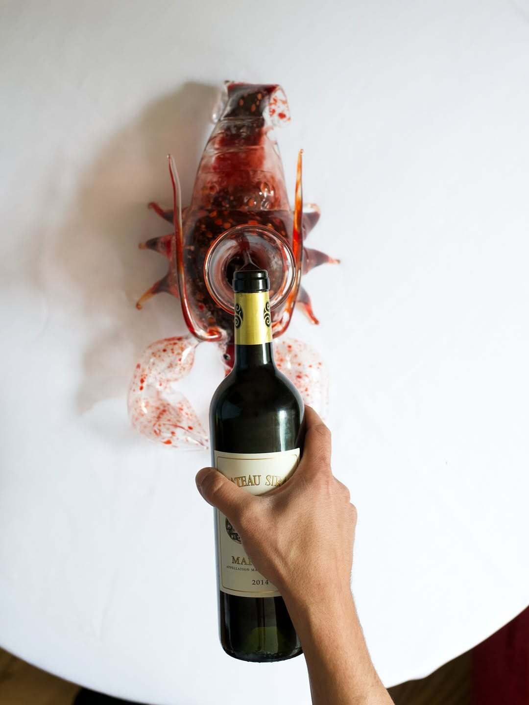 Bottle of wine poured into a carafe at Le Chêne restaurant in New York City.