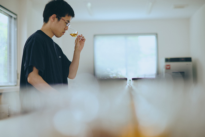 A distillery team member nosing whisky during evaluation at Shindo Distillery in Fukuoka, Japan.